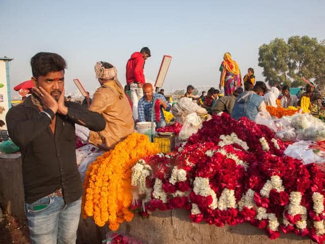Flower traders and garlands for sale at Ahmedabad flower market.