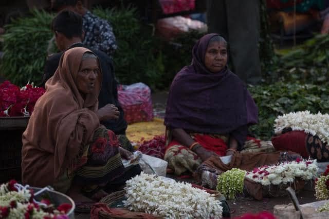 Women selling jasmine flowers at Ahmedabad flower market.
